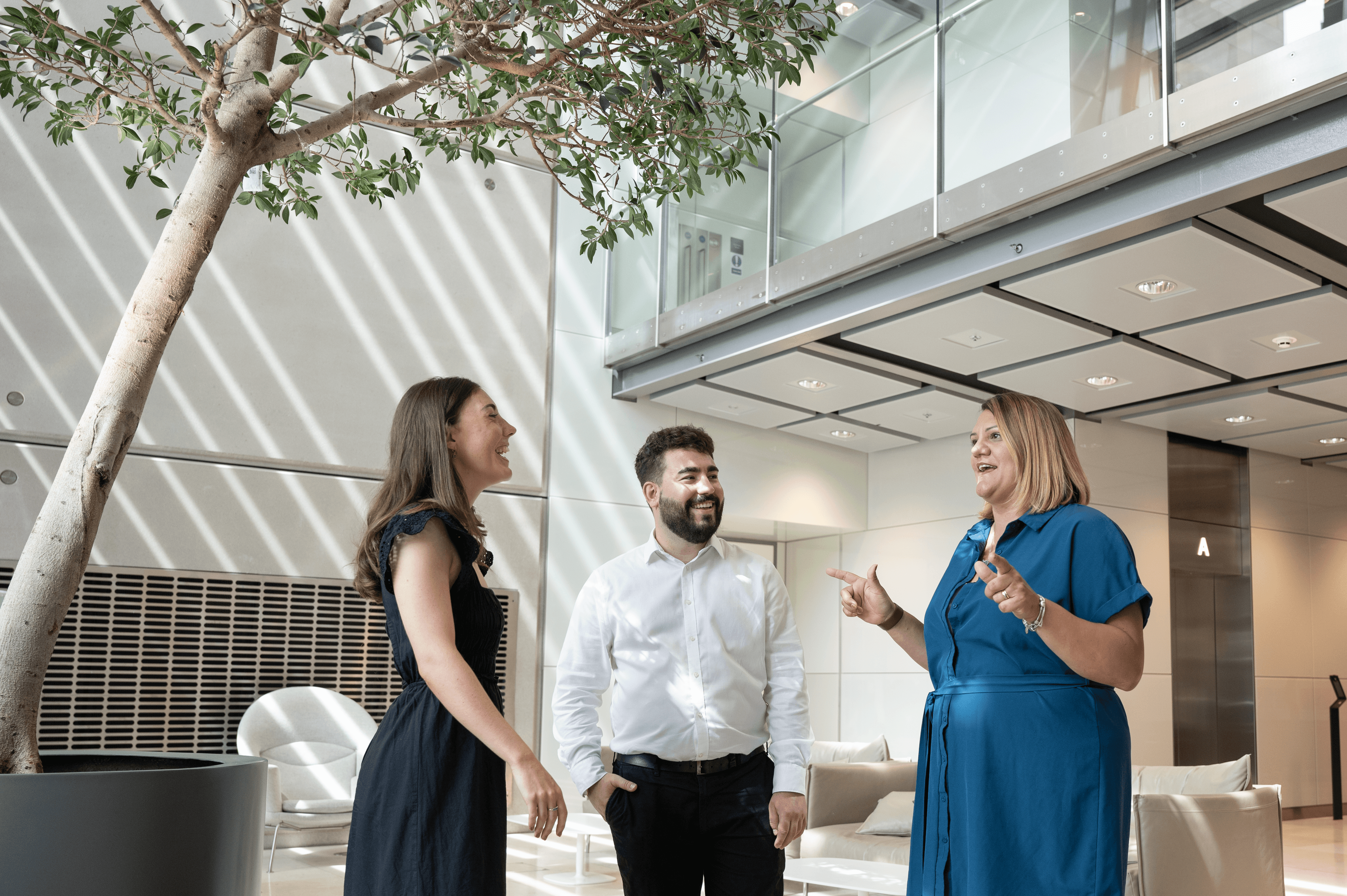 Three members of Cancer Research UK who work in policy, information and communications. They're chatting and looking happy.