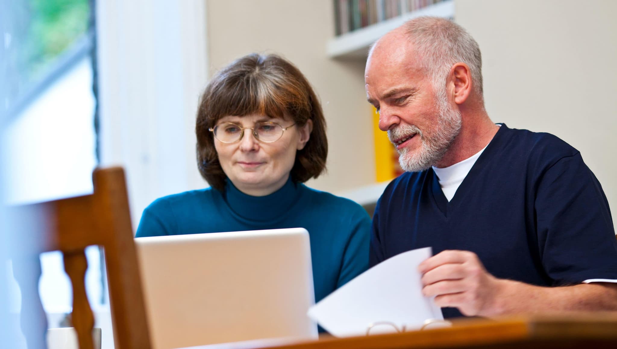 A man and woman with documents.