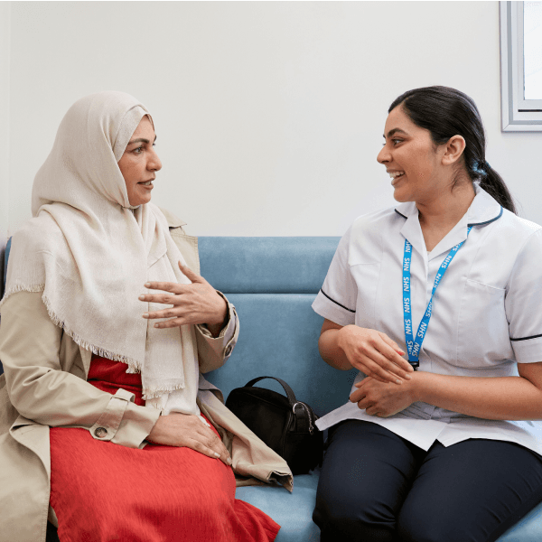 A photo of a nurse talking to a patient.
