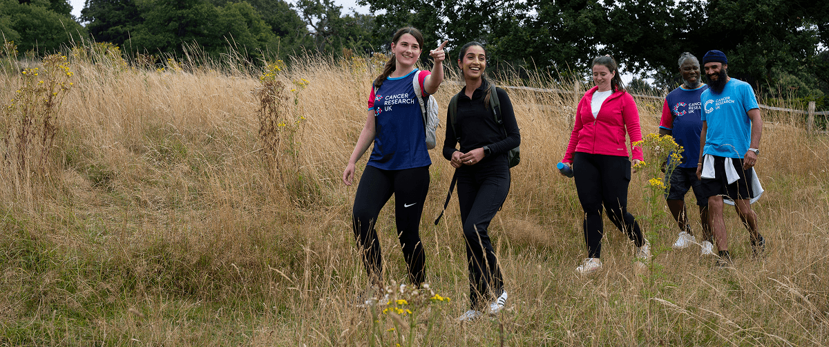 A photo of people wearing Cancer Research UK t-shirts walking outdoors.