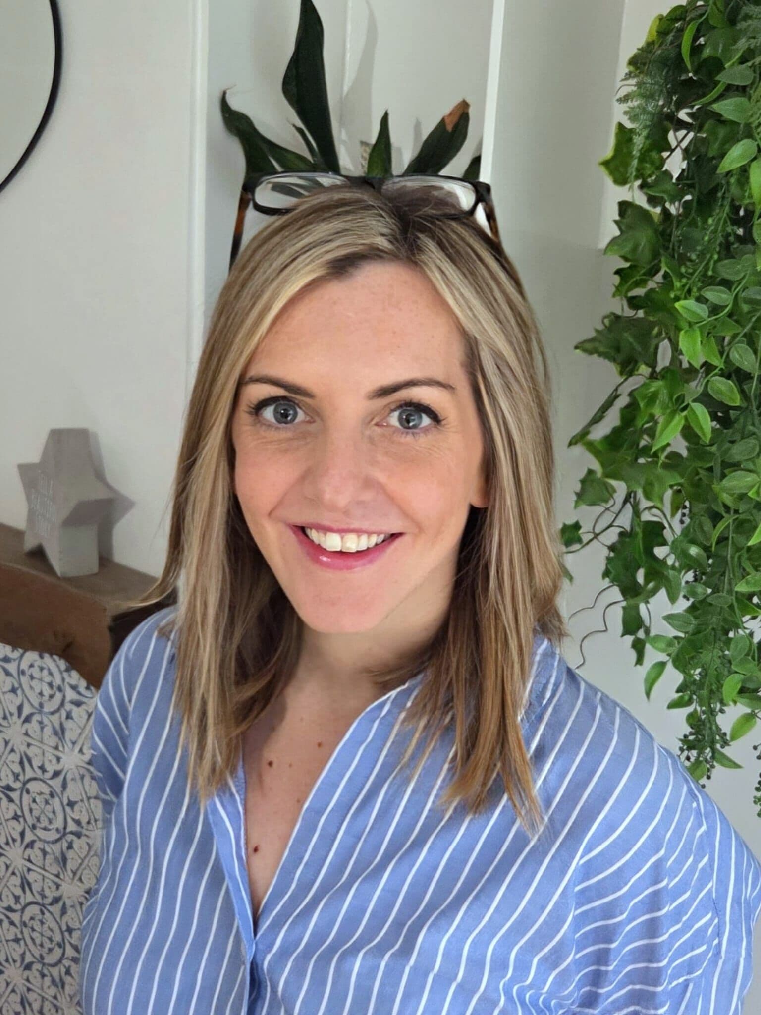 A smartly dressed woman smiling.