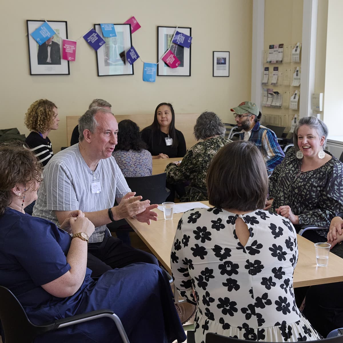 Patient involvement representatives sat in a room in discussion.
