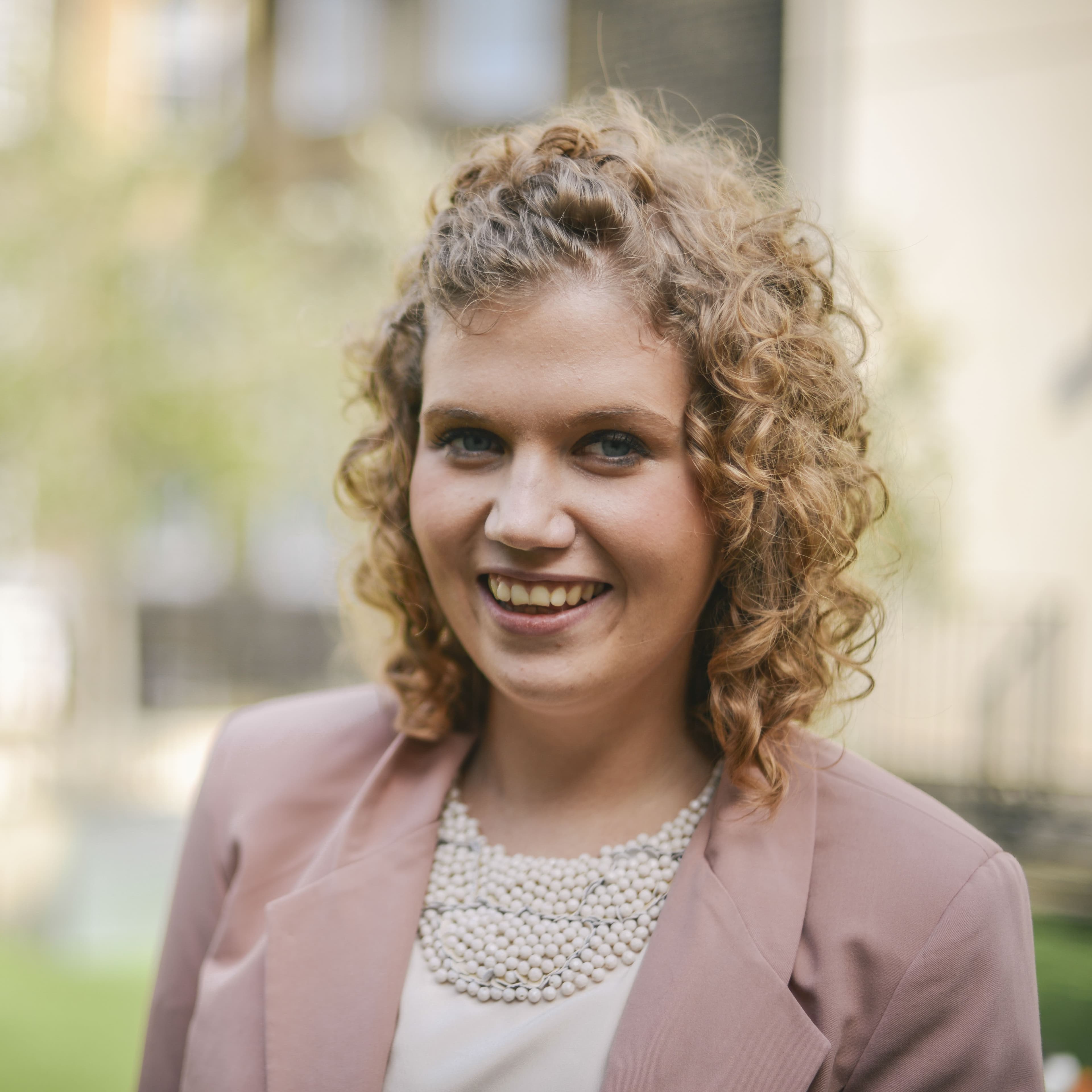 Siwan, a leukaemia patient that has benefitted from Cancer Research UK's research, smiling on a sunny day.