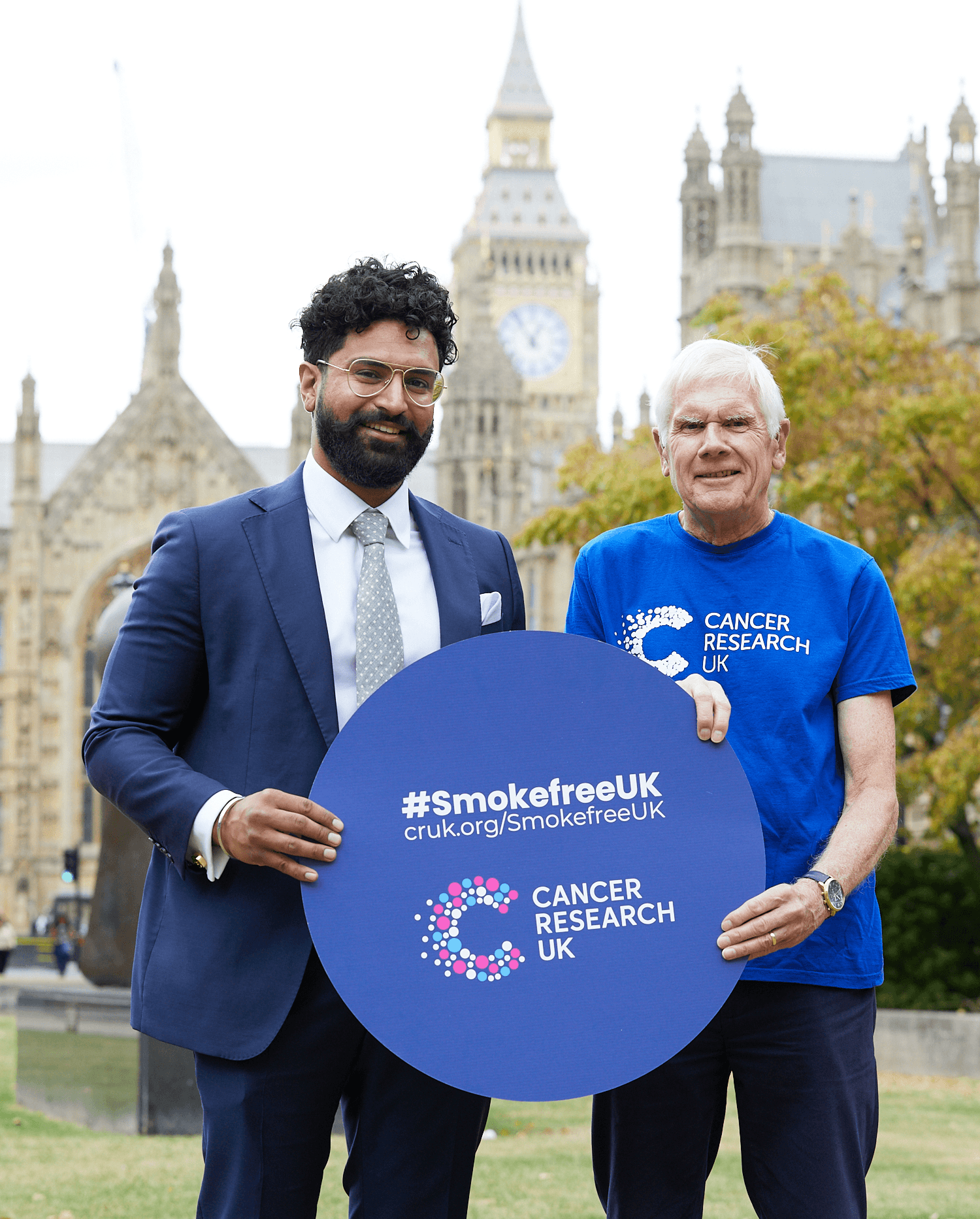 A photo of two Campaigns Ambassadors holding a banner that reads #SmokefreeUK.