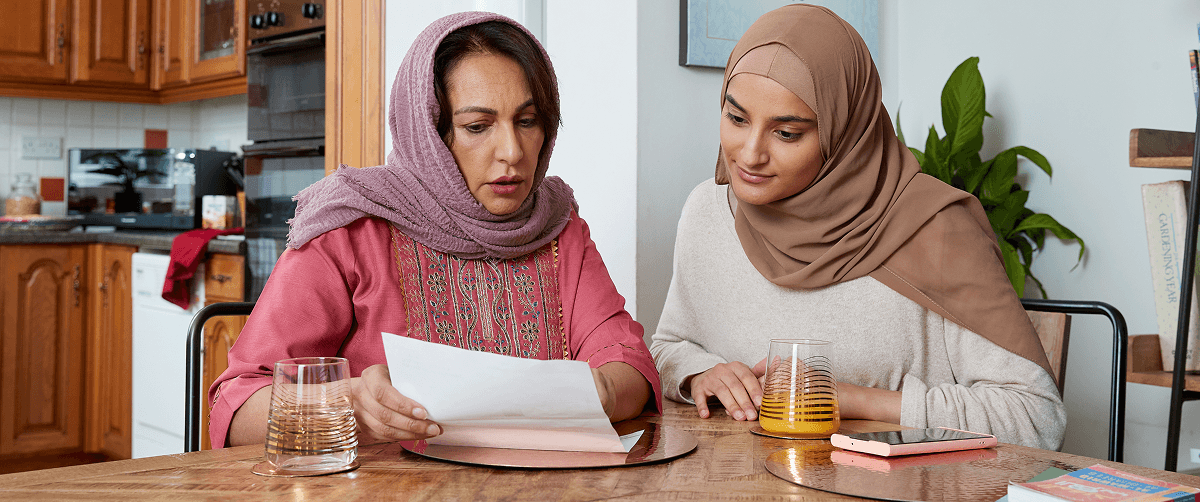 A photo of two people reading screening instructions.