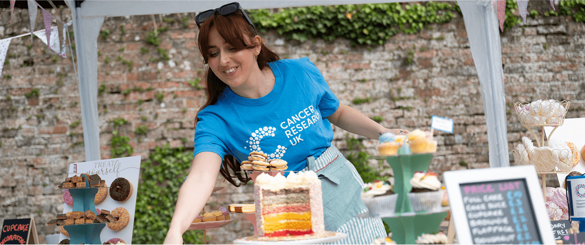 A photo of a Cancer Research UK volunteer at a fundraising event.