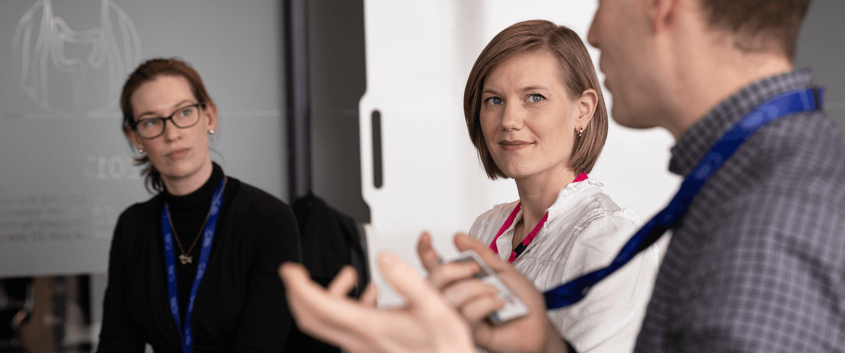 Three people in a meeting.