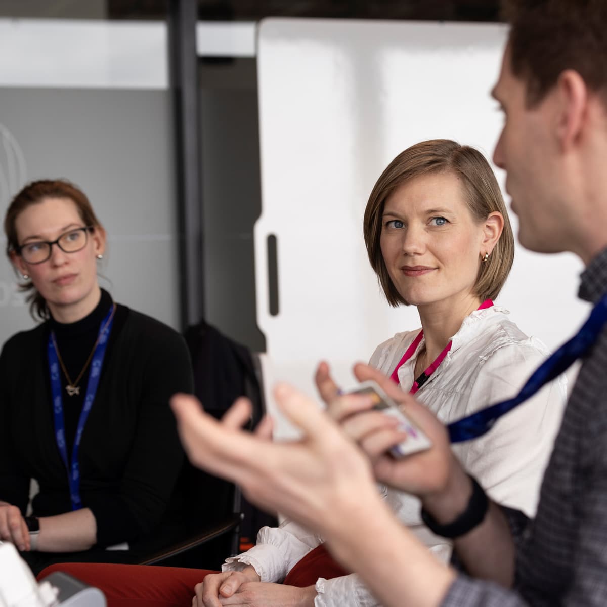 Three people in a meeting.