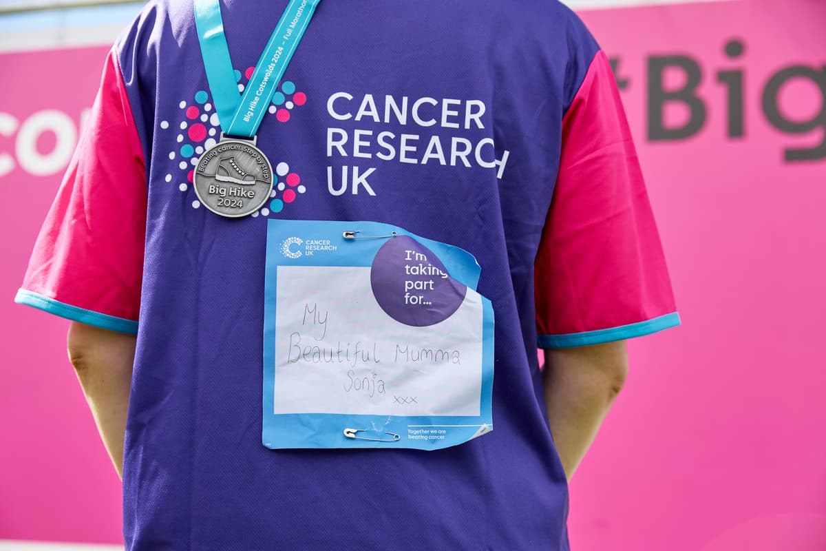 person with tshirt and medal.